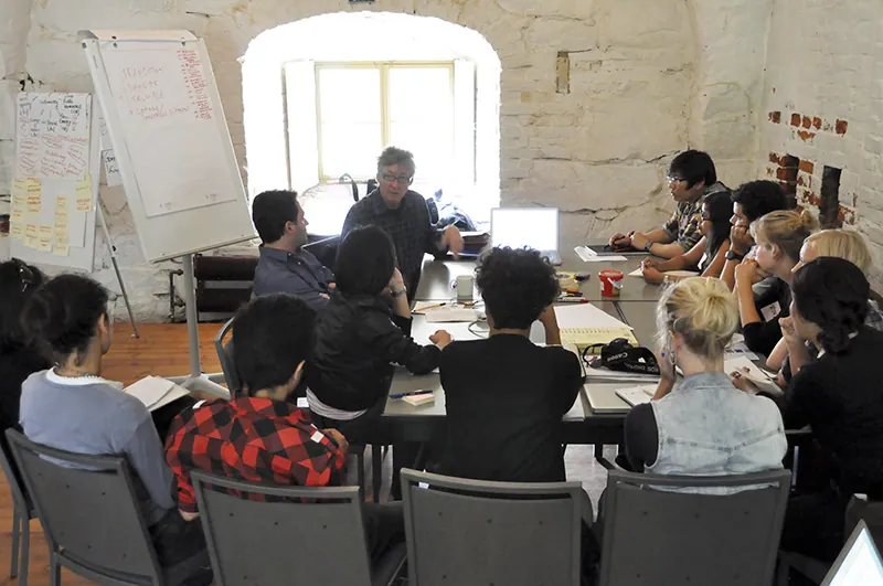 A photo shows a group of diverse students attending a lecture.