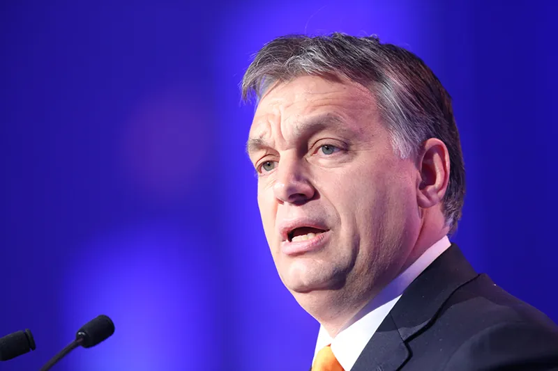 Viktor Orbán speaks into a microphone.