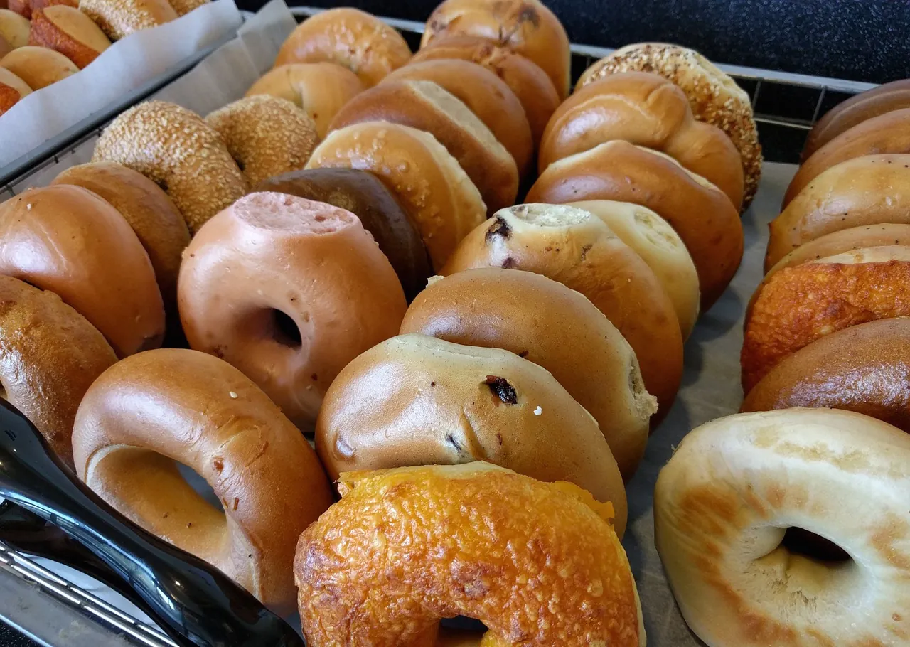 Trays of bagels at a bagel shop.