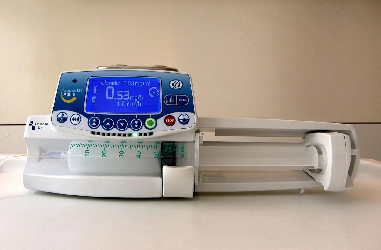 A photograph shows a syringe pump.