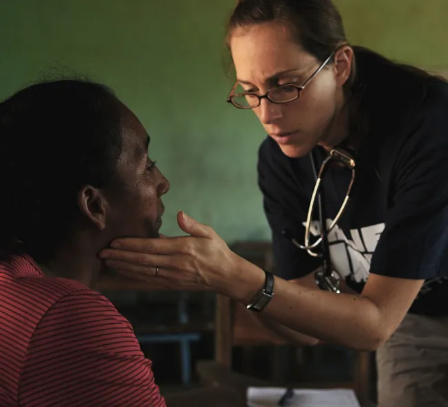Healthcare professional examining older patient