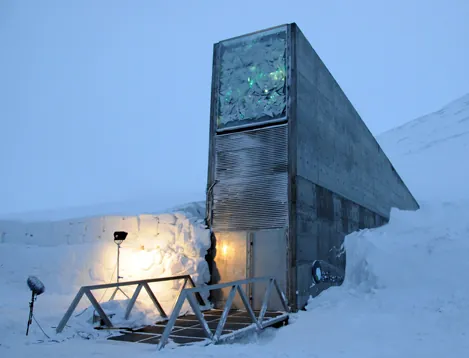 The photo shows a tall structure with a bunker-like door that disappears into a snowbank.