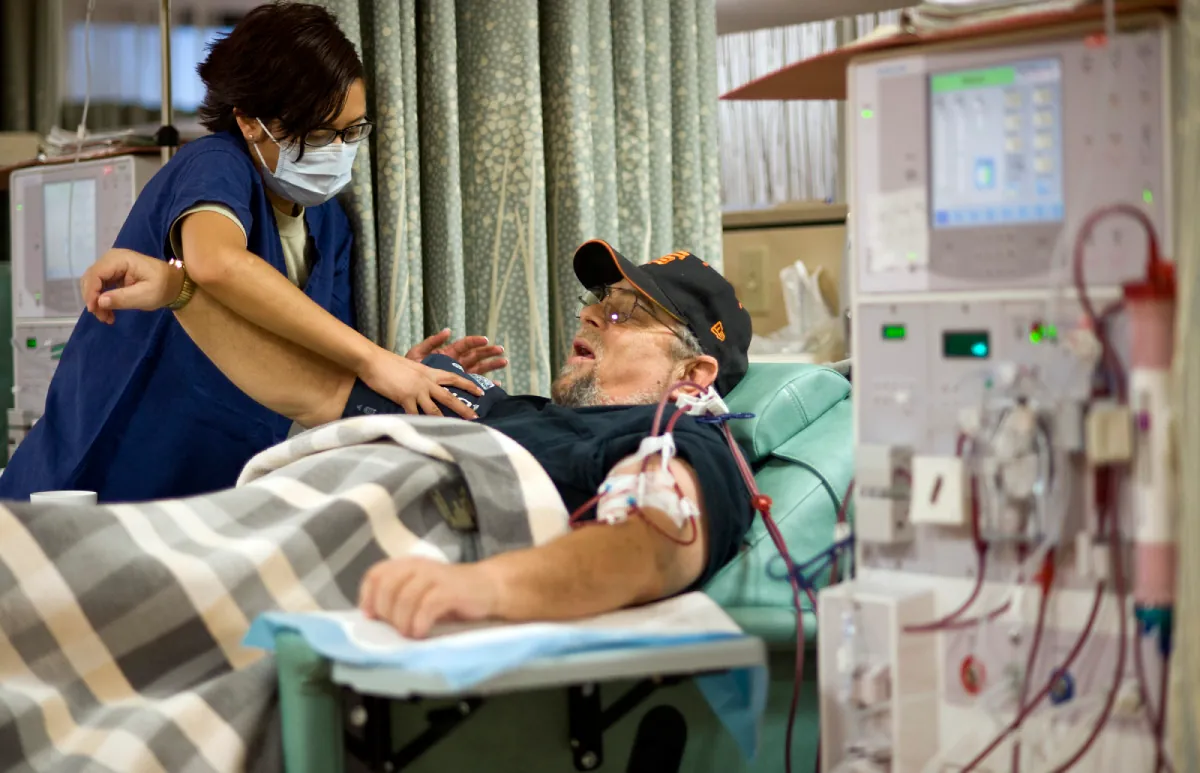 A veteran receiving care from a nurse in a hospital room.