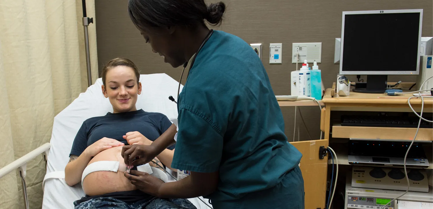 Pregnant patient consulting with healthcare provider.