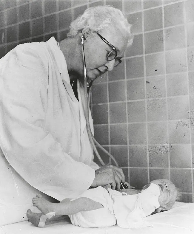 Dr. Virginia Apgar assessing a newborn baby.