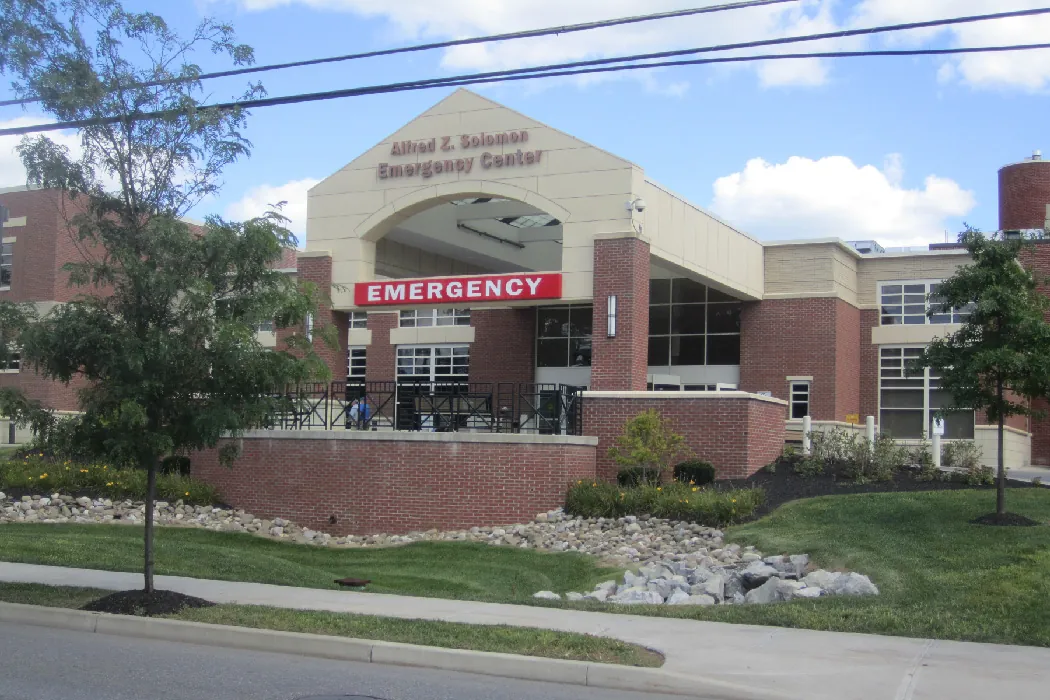 A photograph shows the entrance to a hospital emergency department.