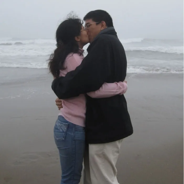 Photo of two individuals kissing on a beach.