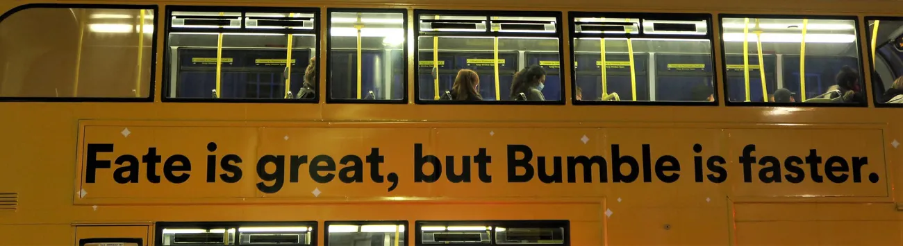 A photo shows a bus with the slogan, “Fate is great, but Bumble is faster.”