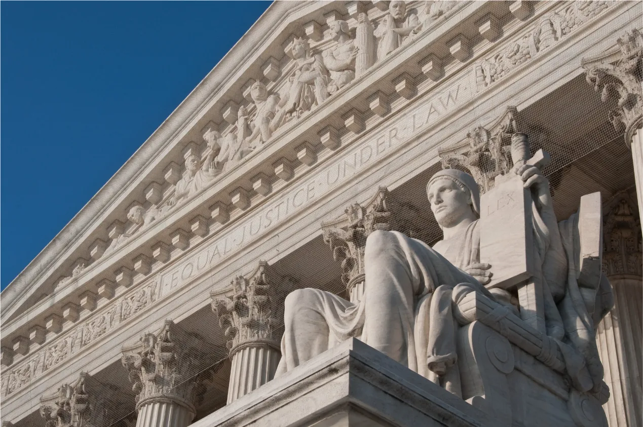 The Guardian statue by James Earle Frasier in front of the United States Supreme Court building in Washington, DC. The statue is seated holding a tablet of laws with the word "Lex" on it, and with a sheathed sword.