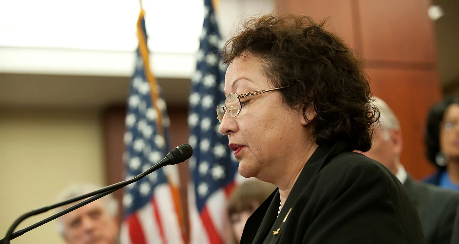 Carmen Morales-Board speaking at a microphone.