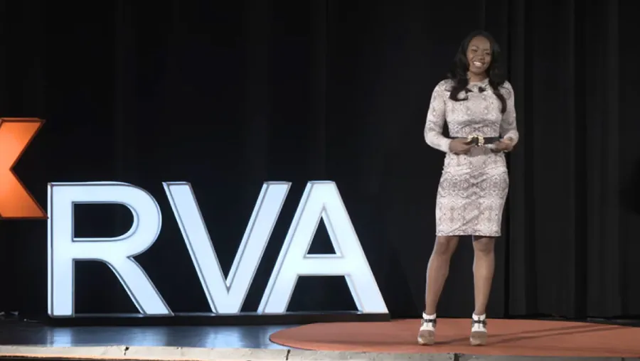 A photo shows Keisha Howard standing on a stage.