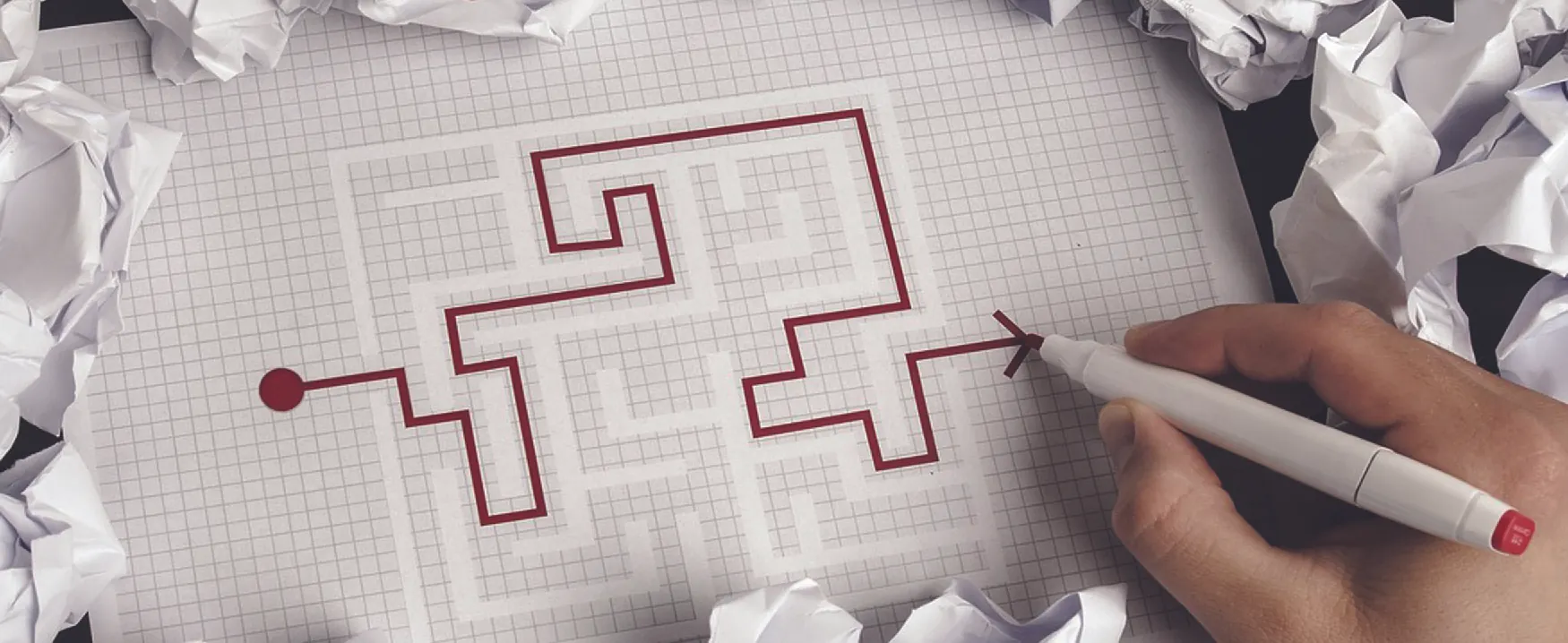 Photo of someone solving a maze puzzle.