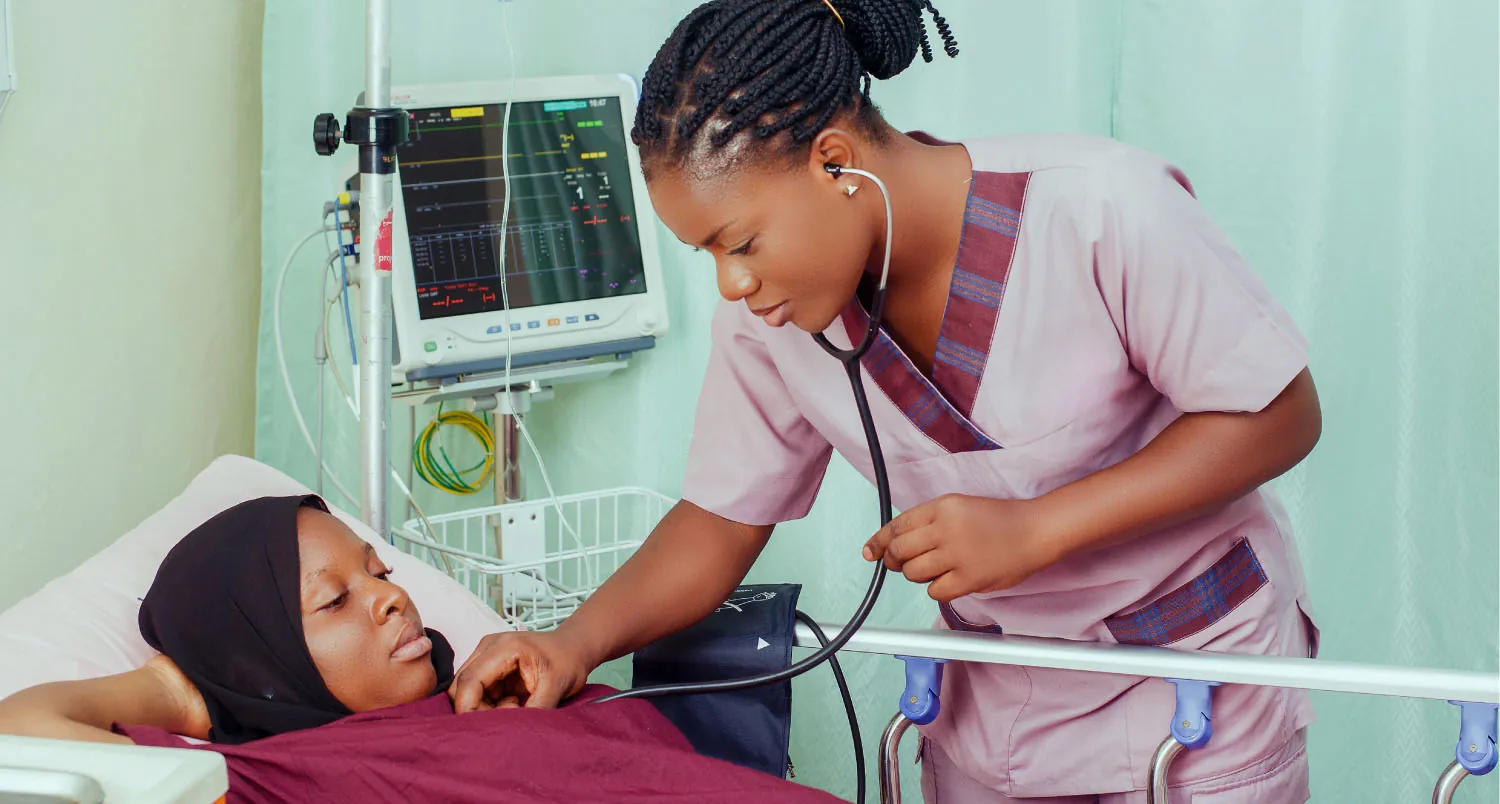 Nurse using stethoscope to examine patient.