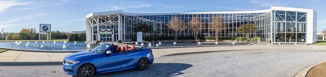 Photo shows a M235i BMW vehicle parked outside of the Spartanburg BMW Zentrum facility.
