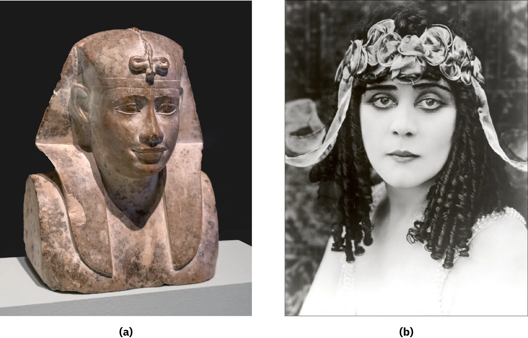Two photographs of images are shown. (a) This image shows a shiny-brownish stone statue of a bust with almond shaped eyes, a triangular nose and full lips in a smile. The figure wears a plain headdress that goes behind the ears in a triangle and hangs down in the front on their chest. An upside down cross-like knotted figure hangs from the top of the headdress over the forehead. The bust is plain and darker in some areas. (b) A black and white photograph of a woman is shown wearing a bright white shirt that fades into her skin color with beaded straps. She has pale skin, dark round eyes, black straight eyebrows, and long very curly hair. She wears a headband of flowery ribbons around her head with a curved ribbon sticking out on each side. The background is blurry gray colors.