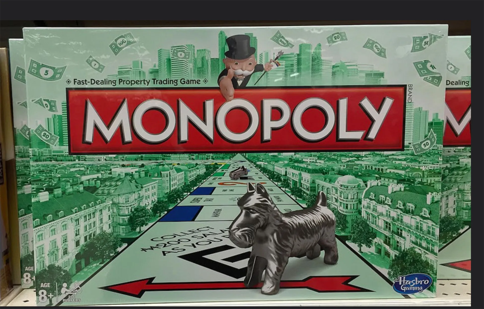 The classic Monopoly board game, featuring Mr. Monopoly and the iconic Scottie dog token, displayed on a shelf, ready for a fun property trading session.