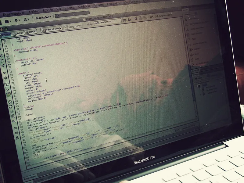 A laptop screen shows coding.