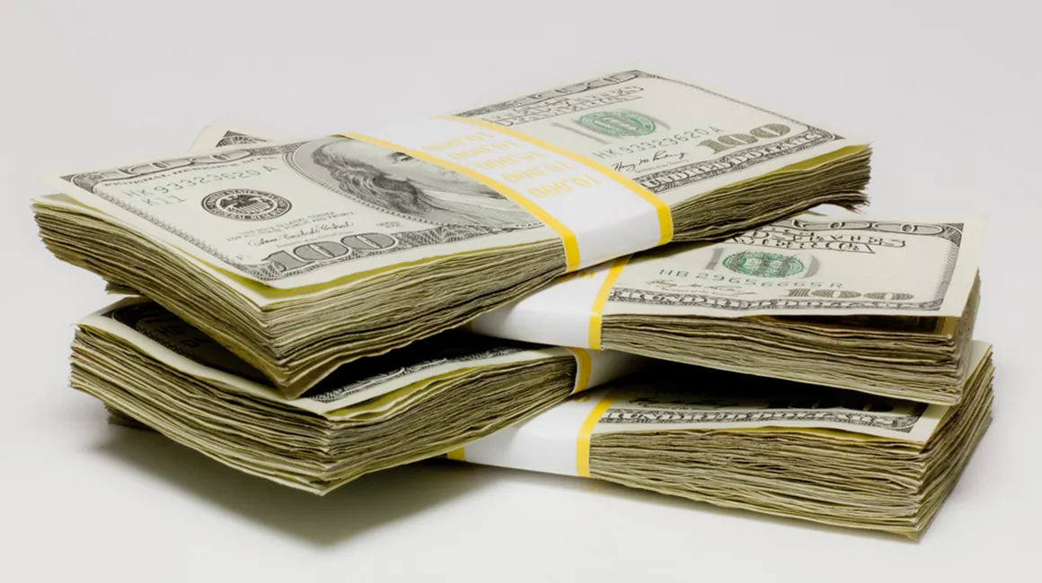 Four bundles of currency notes are stacked one above the other.