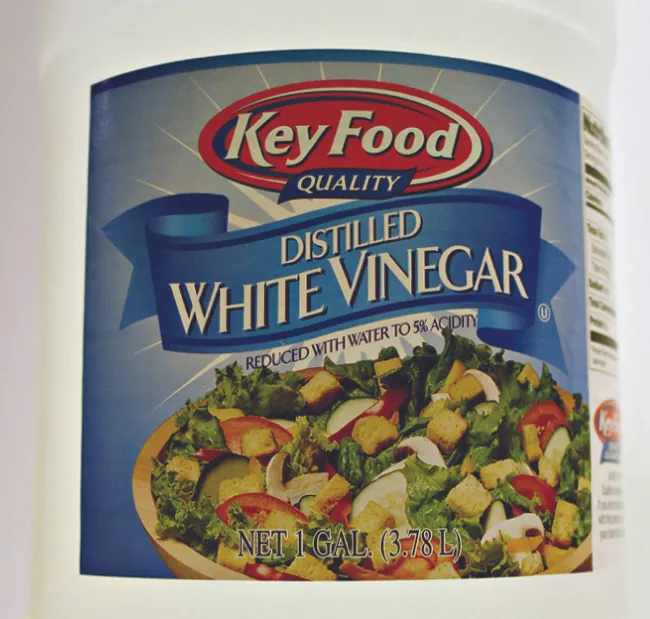 An image shows the label of a bottle of distilled white vinegar. The label states that the contents have been reduced with water to 5 percent acidity.