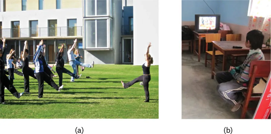 (a) Photo of yoga class outside. (b) Photo of child sitting at table watching television.