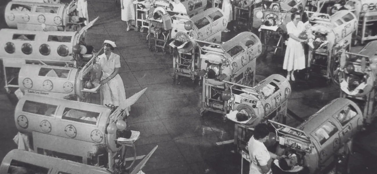 Photo of a room full on patients in large chambers that cover their entire bodies.