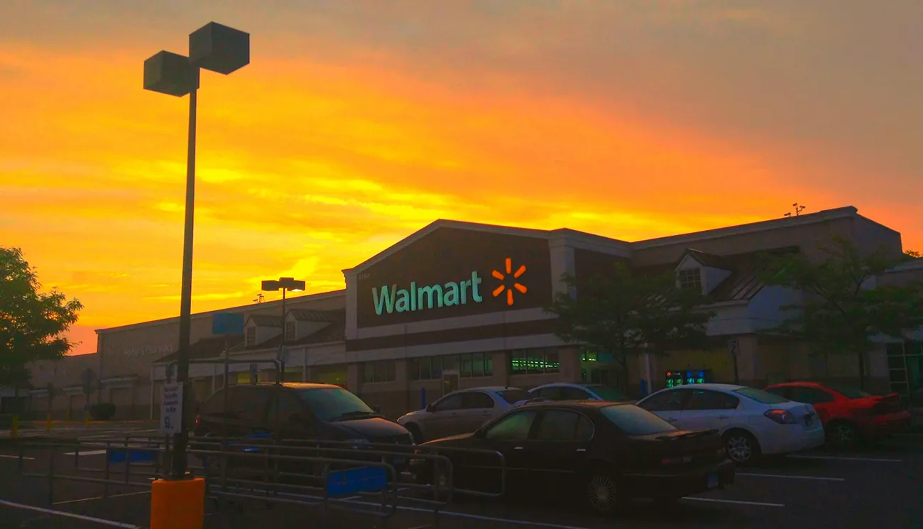 A photograph shows the front entrance of a Walmart store.