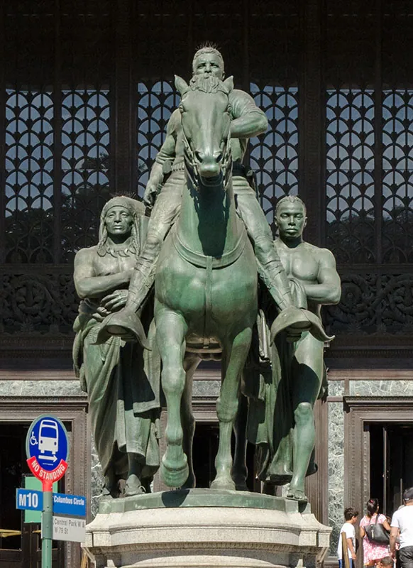 Equestrian Statue of Theodore Roosevelt, located in New York City and created by James Earle Fraser, shows Roosevelt astride a horse while a Native and a Black person walk on either side of him.