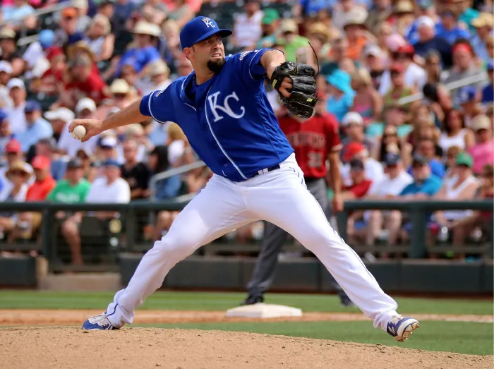 A baseball player pitching a ball.