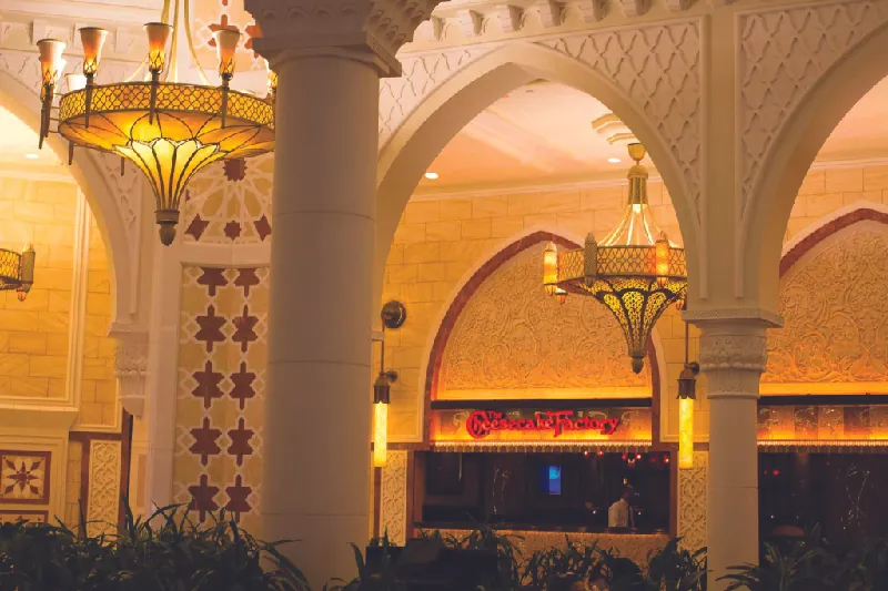 This image shows a Cheesecake Factory restaurant located in a mall in Dubai.
