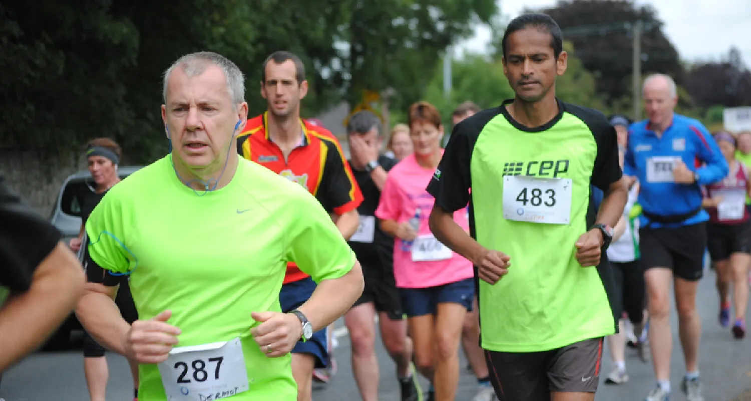 People run in a road race.