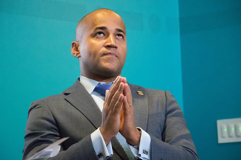A photo shows Dante Disparte with hands clasped in prayer as he looks up.