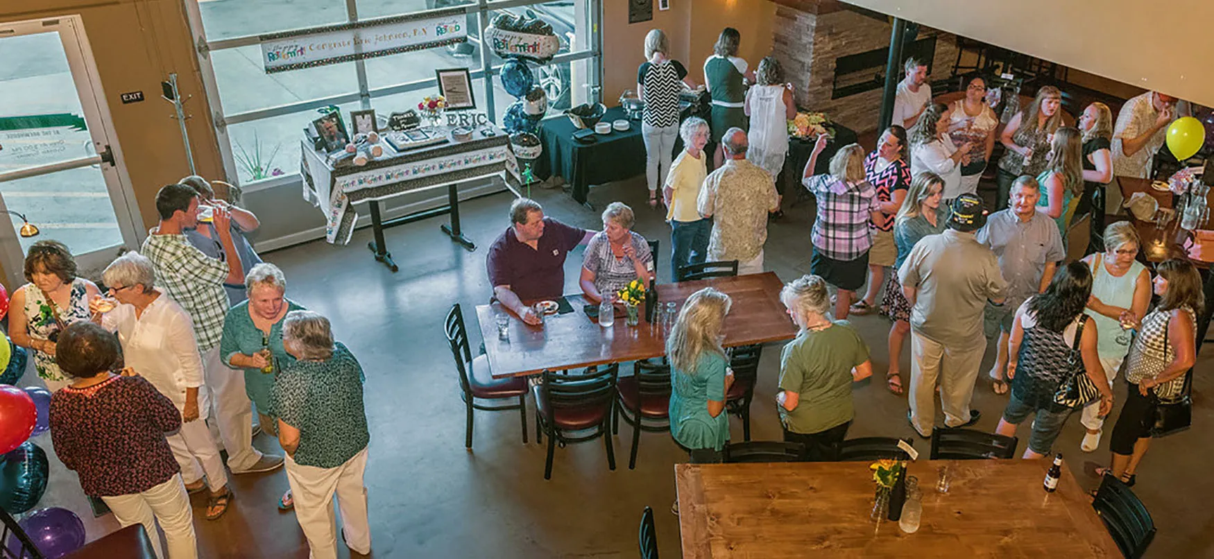 A group of people are gathered for a retirement celebration.