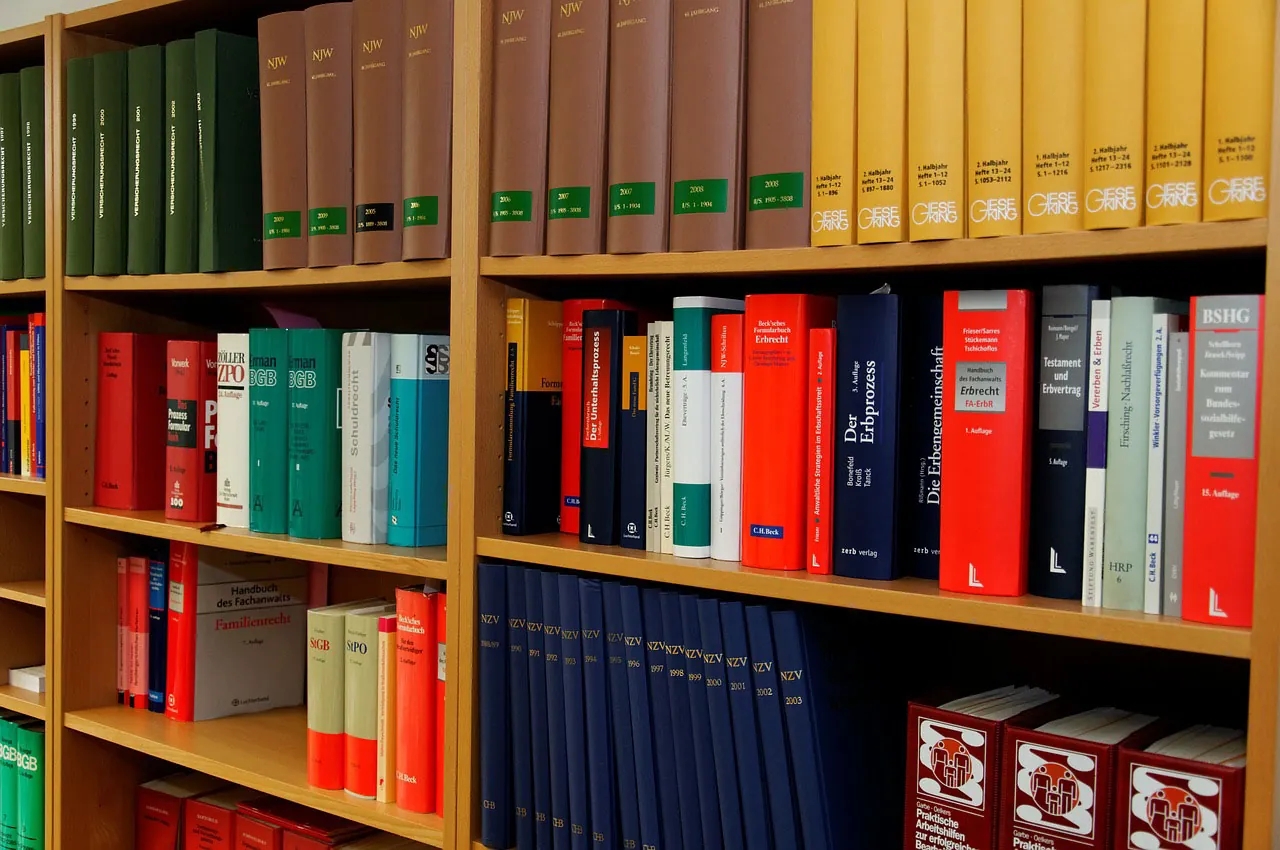 A bookshelf lined with various law-related books.