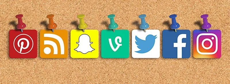 A collection of social media icons, including Pinterest, social wifi, Snapchat, Vimeo, Twitter, Facebook, and Instagram, are pinned to a bulletin board.