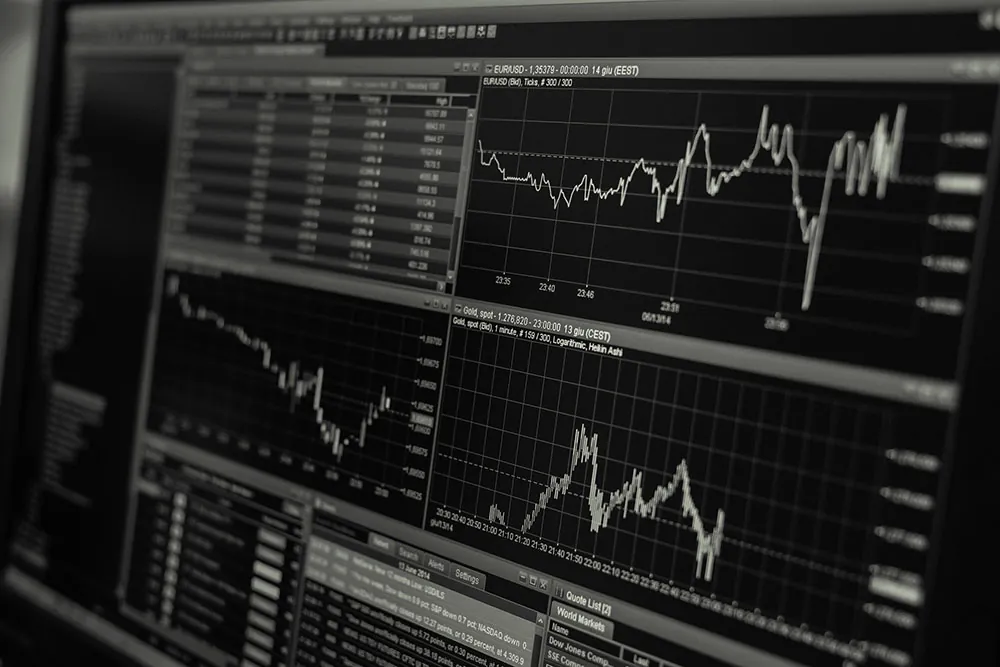 A photo of a screen that shows a variety of line charts depicting securities activities.
