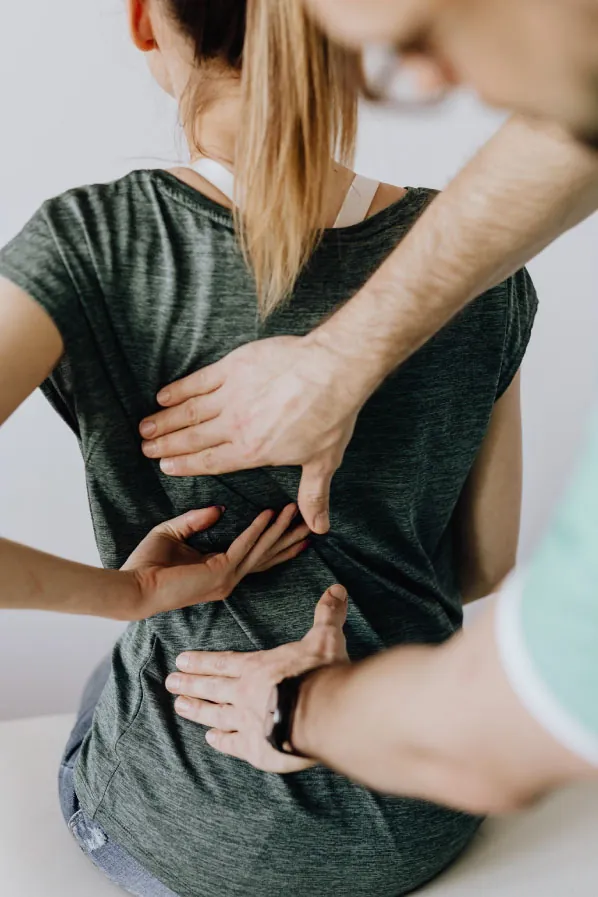 Photo of person feeling back of another person.