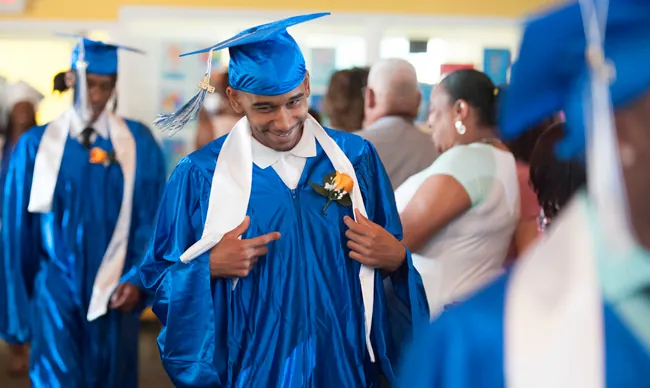 Graduates are shown in graduate attire.