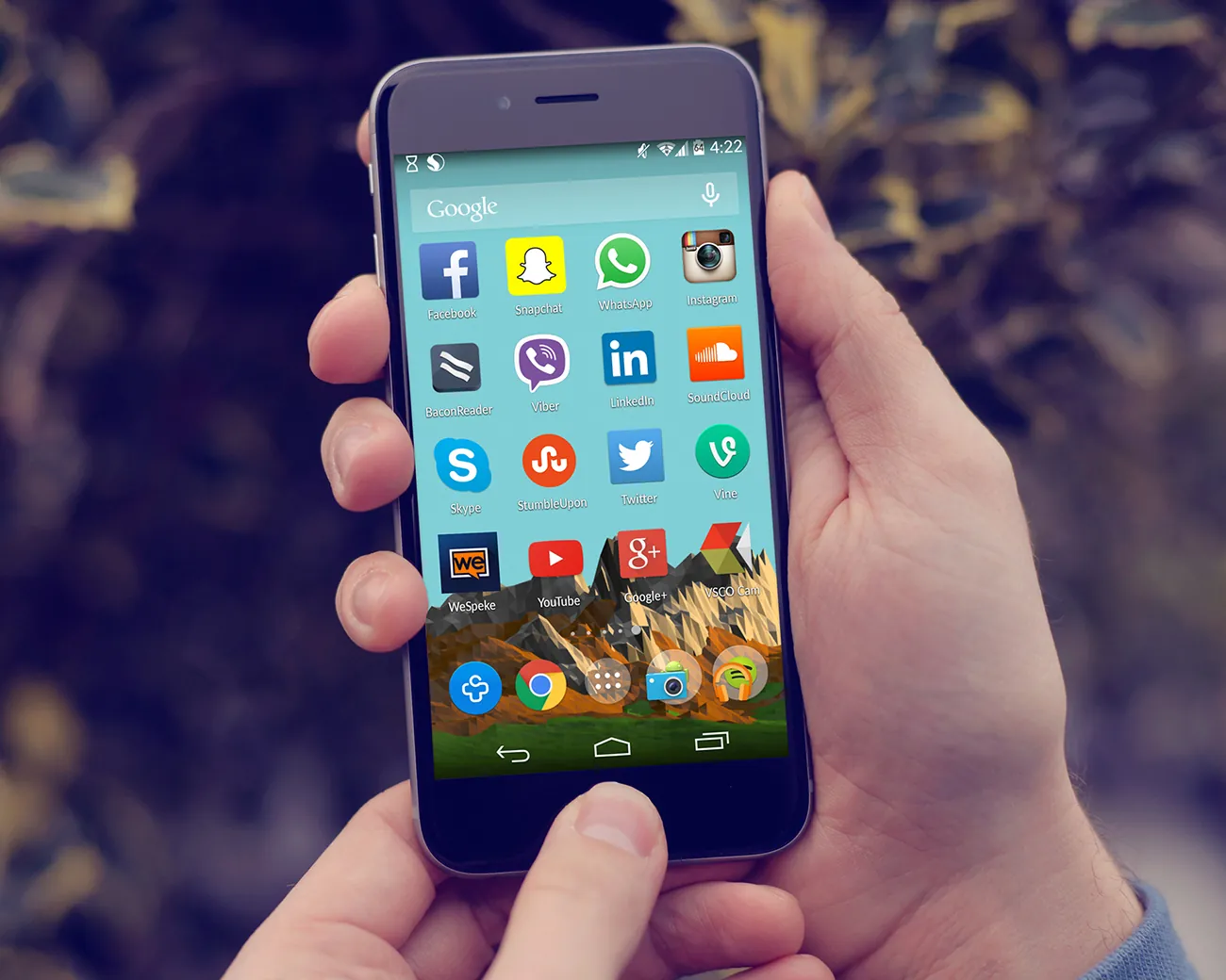 A photograph shows a cell phone screen, with many apps, including Facebook, Skype, Twitter, LinkedIn, and Instagram.