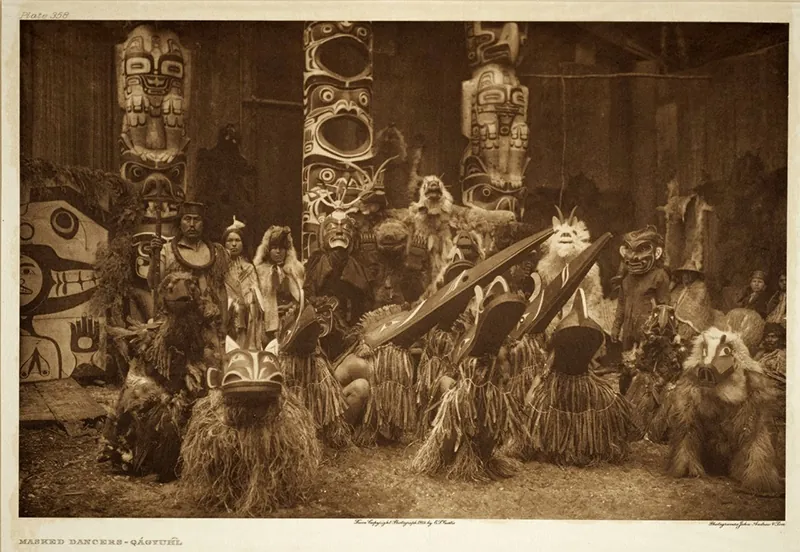 A group of native people all dressedin native dress at an event.